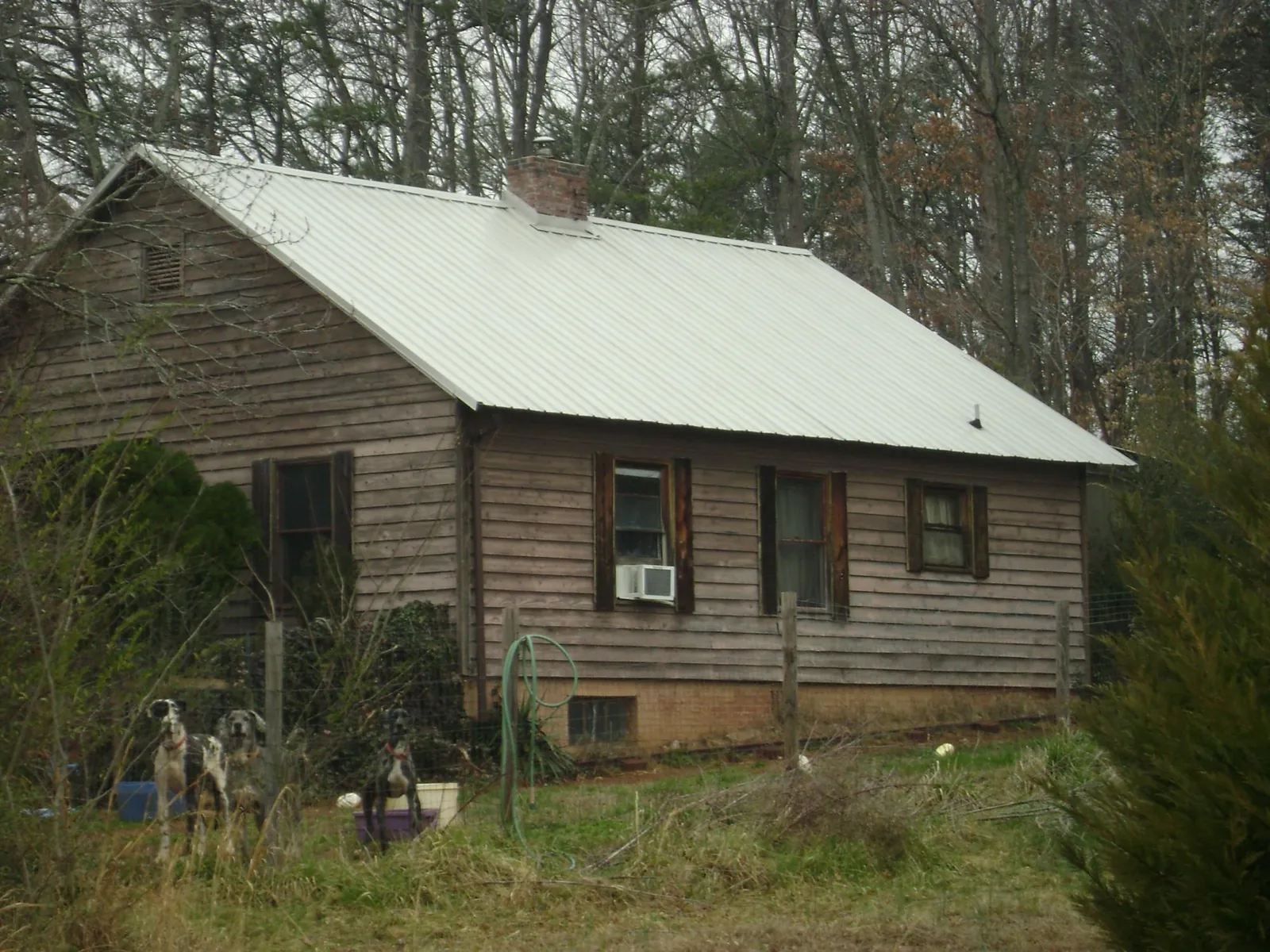 White metal roof on an old wood sided farmhouse, from a Metal Roof Installation job in Wadesboro